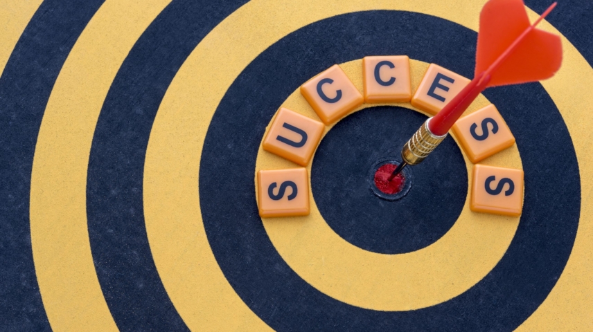 Dart Hitting The Bullseye Target With Word Success On Dartboard